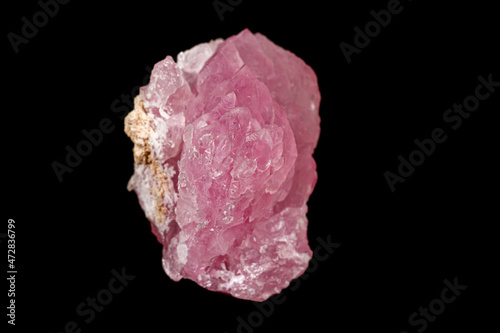 Macro pink quartz mineral stone on black background