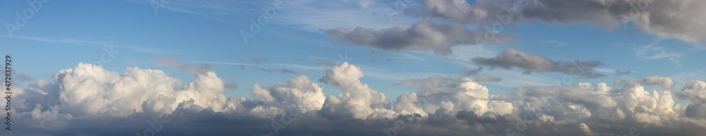 Panoramic View of Cloudscape during a cloudy blue sky sunny day. Taken on the West Coast of British Columbia, Canada. Panoramic View of Cloudscape during a cloudy blue sky sunny day. Taken on the West Coast of British Columbia, Canada.