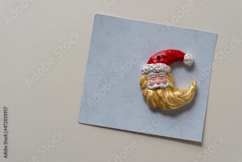 santa face christmas ornament isolated on fancy paper photo