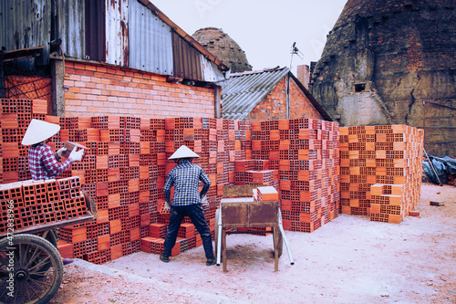 Workers in the traditional brick-making village along the banks of the Co Chien River in Vinh Long Province, Vietnam