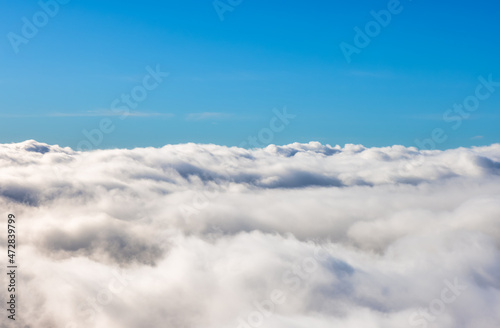 Fototapeta Naklejka Na Ścianę i Meble -  Aerial View from Above the White Puffy Clouds during a sunny day. Taken from Grouse Mountain, North Vancouver, British Columbia, Canada.