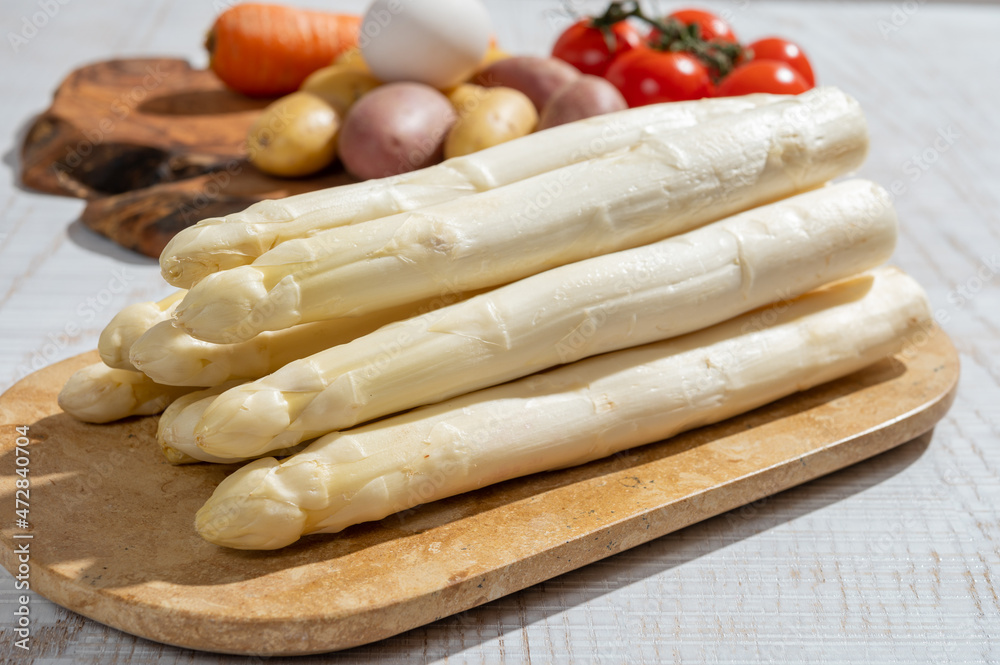 New harvest of high quality Dutch white asparagus washed, uncooked, tasty vegetarian dinner