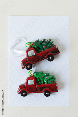 two christmas tree ornaments on paper photo