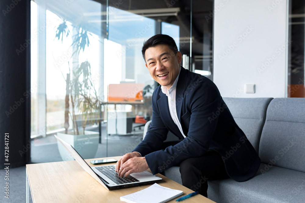 Successful and happy asian man working online remotely on laptop smiling happy with plan and task Successful and happy asian man working online remotely on laptop smiling happy with plan and task