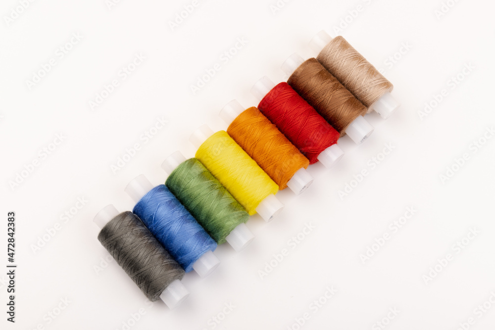 Color sewing threads isolated on white background. Different colors.Bright bobbin thread. Color sewing threads isolated on white background. Different colors.Bright bobbin thread.