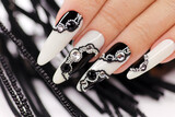 Black and white manicure with rhinestones on long gel nails.