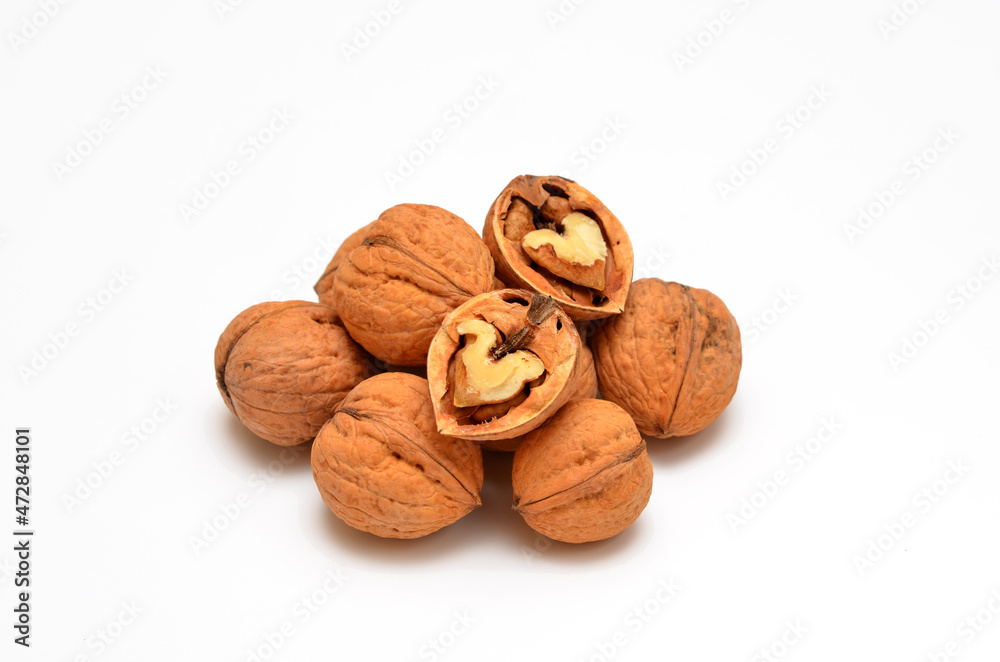 whole and halved walnuts isolated on white background whole and halved walnuts isolated on white background