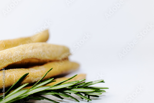 Traditional Italian grossing with rosemary on a white background photo