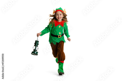Happy smiling little girl dressed like funny gnome or elf posing isolated over white studio background. Winter, holiday, christmas concept