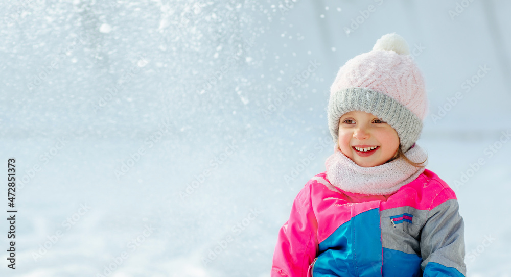 A kid have fun playing in the snow in winter, positive mood laughter and smiles. A kid have fun playing in the snow in winter, positive mood laughter and smiles.