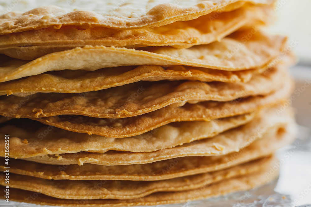 Layers of baked crumpets cakes made of puff pastry for cake. Semi-finished product for cake. Layers of baked crumpets cakes made of puff pastry for cake. Semi-finished product for cake.
