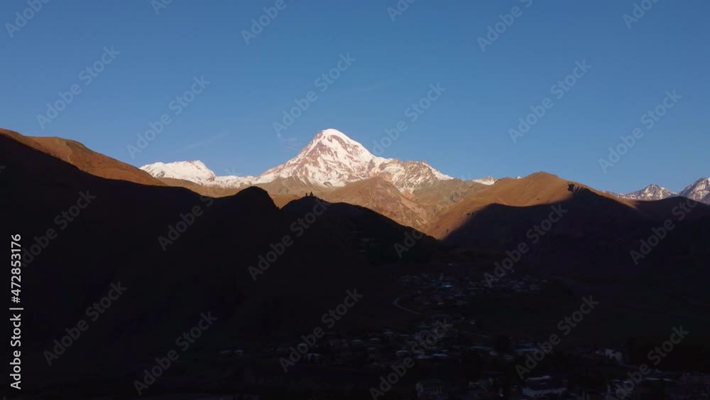 Snowy mountain against blue sky