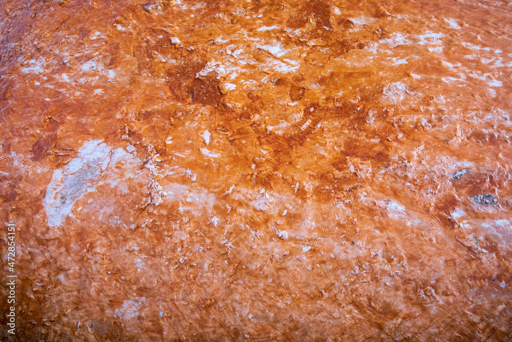 Colorful orange tot spring mineral texture background. Yellowstone National Park.