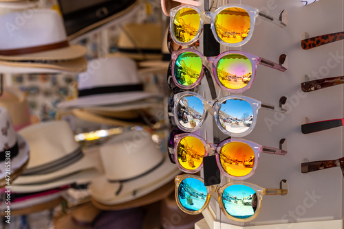 Colorful sunglasses on a stand. Summer eyeglasses, fashion collection. Summer in Greece