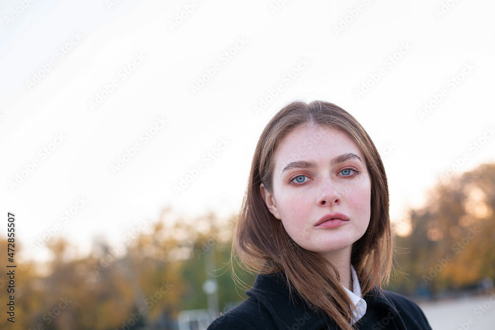 Long straight haired white european woman with blue eyes in dark coat portrait Long straight haired white european woman with blue eyes in dark coat portrait