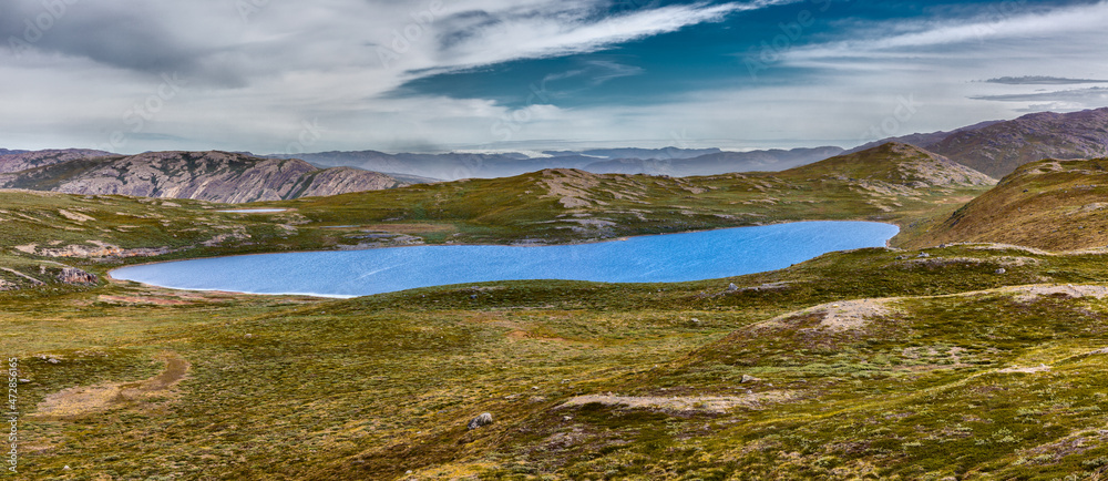Panorama of a landscape with tundra, lakes and mountains in the vicinity of Kangerlussuaq, Greenland