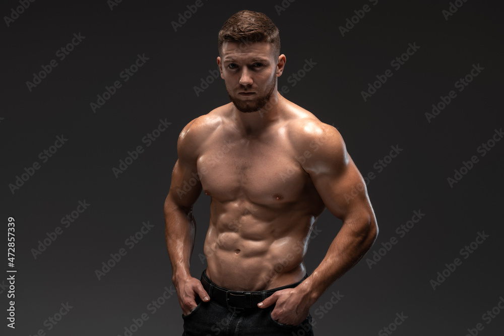 Portrait of man looking at camera with serious face. Young caucasian guy is half naked. Sport and bodybuilding concept Portrait of man looking at camera with serious face. Young caucasian guy is half naked. Sport and bodybuilding concept