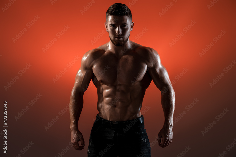 Portrait of young caucasian guy is half naked. Man looking at camera with serious face. Sport and bodybuilding concept
