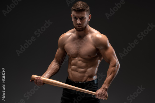 Photography Waist up portrait view of muscle man posing in studio with baseball bat