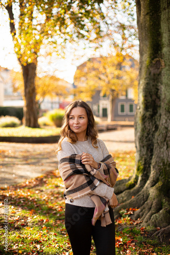 European white young woman with brown hair near the tree in autumn park © PIXbank