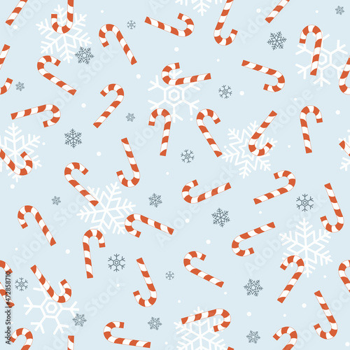 Blue Christmas seamless pattern with red candy cane and snowflakes