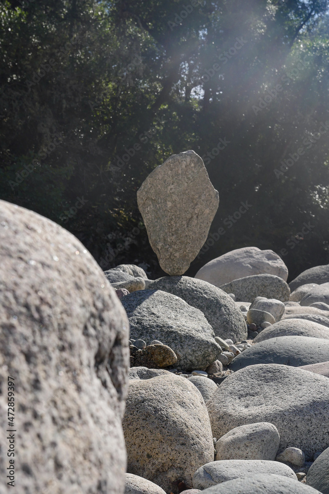 Fototapeta premium Natural stones layered to a figure on a mountain lake