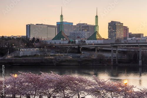 Portland, Oregon. Cherry trees in bloom on the Willamette River in downtown. Oregon State Convention Center across the river.