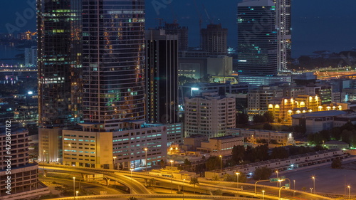 Office buildings in Dubai Internet City and Media City district aerial night to day timelapse