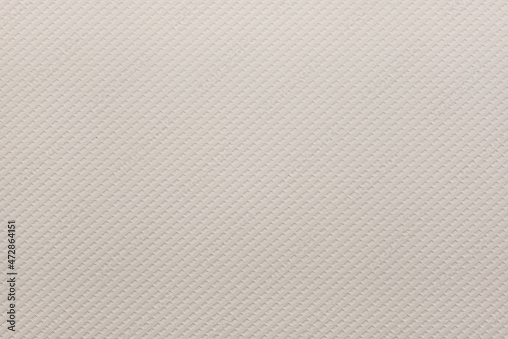 A dense industrial sheet of grey paper with a textured surface A dense industrial sheet of grey paper with a textured surface