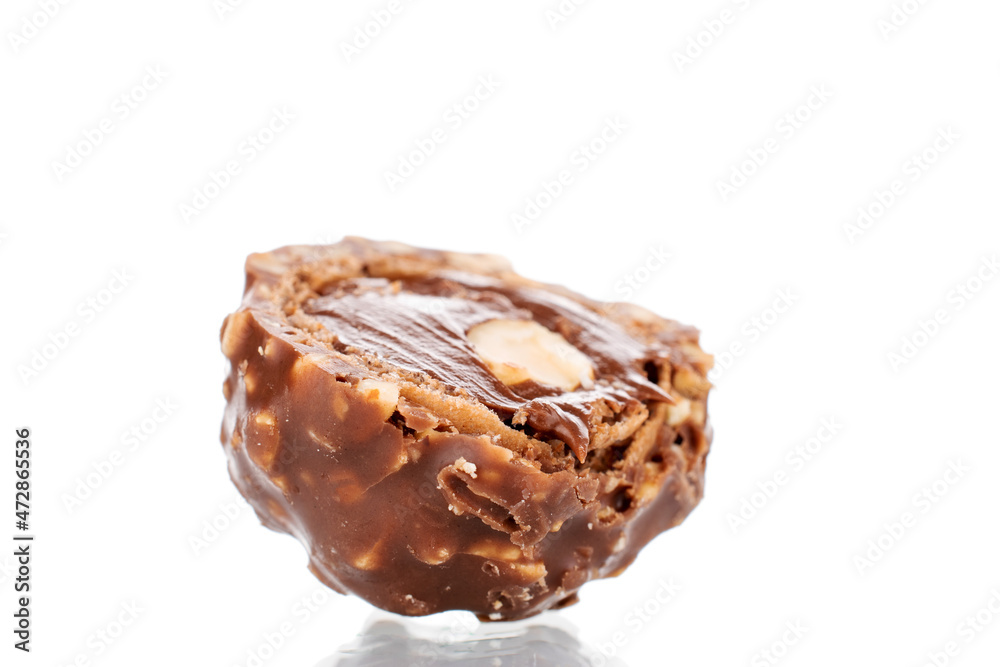 One half of chocolate candy with nuts, close-up, isolated on white. One half of chocolate candy with nuts, close-up, isolated on white.