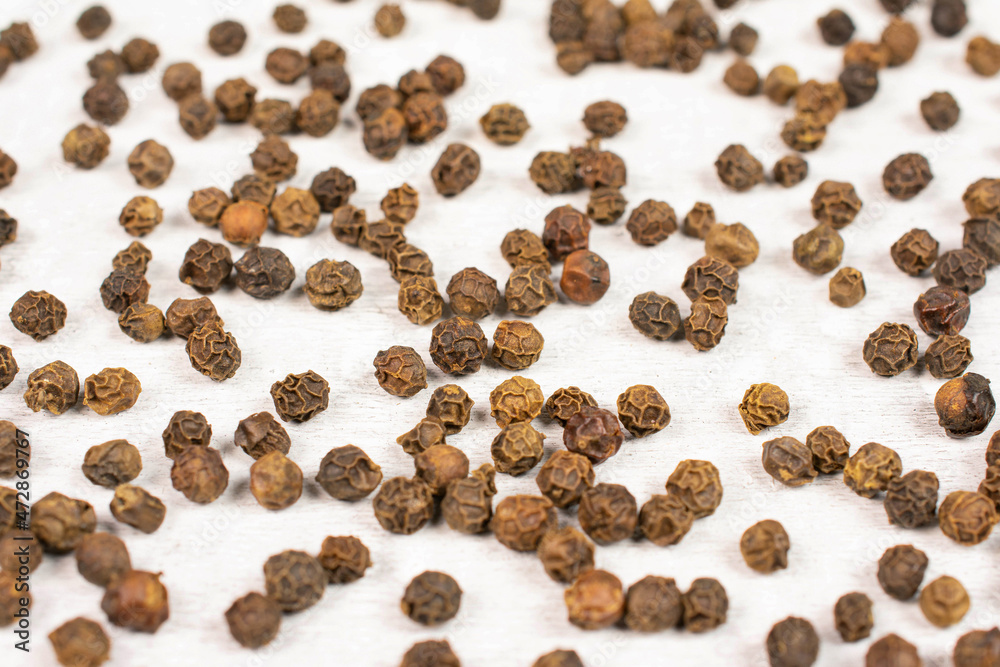 Lot of whole spicy black pepper isolated on white background Lot of whole spicy black pepper isolated on white background