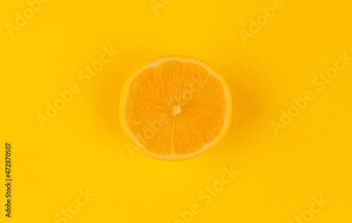 Yellow background with a round slice of lemon