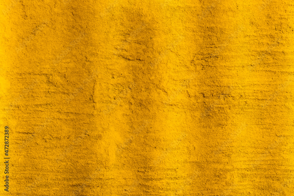 Gold color old cement wall with rough texture for background Gold color old cement wall with rough texture for background
