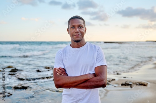 Outdoor portrait of smiling young African American man looking in camera