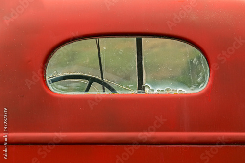 View of rear window on old abandoned red truck, Palouse region of eastern Washington. photo