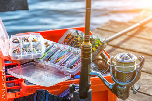 A large fisherman's tackle box fully stocked with lures and gear for fishing.fishing lures and accessories. fishing spinning. Kit of fishing lures.
