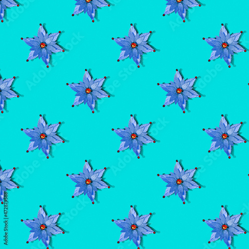 Seamless Christmas texture of stars on a blue background. Pattern