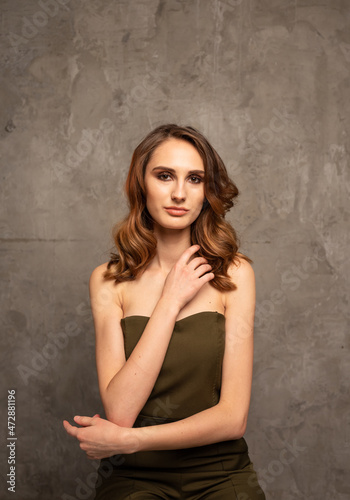 a model girl with New Year's makeup on a gray background with a place for text