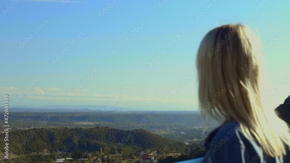 free, happy young woman traveler in denim jacket, looking into distance at mountains and valley with clouds from height standing on hill, breathing fresh air, Mountains, concept of freedom, Happiness free, happy young woman traveler in denim jacket, looking into distance at mountains and valley with clouds from height standing on hill, breathing fresh air, Mountains, concept of freedom, Happiness