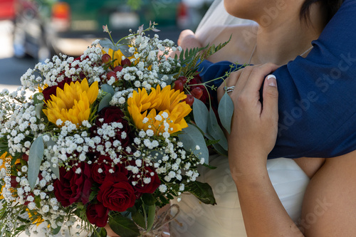 Bride and Groom holding a bouquet of flowers