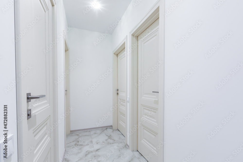 Interior of corridors in a large apartment with white walls Interior of corridors in a large apartment with white walls