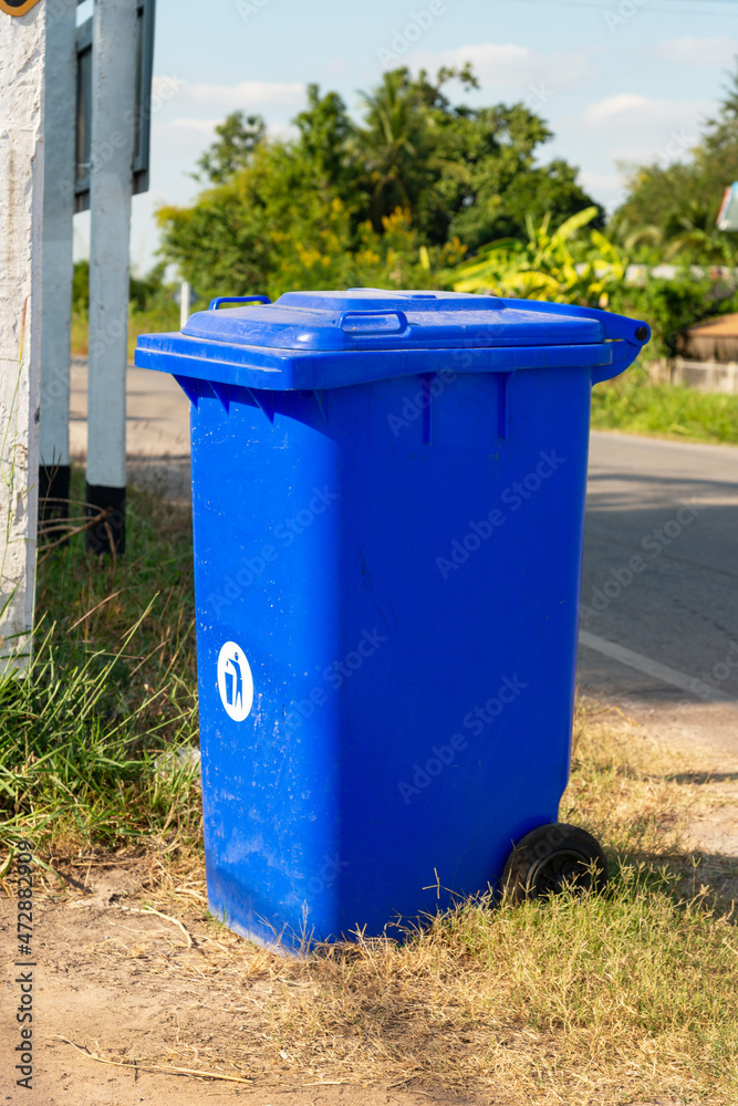 Blue recycle bin at road side garbage bins in outdoor. Stock