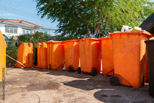  Orange rubbish bin in a public place. essential equipment to keep the environment clean and comfortable, Orange Plastic Waste Container Or Wheelie Bin.