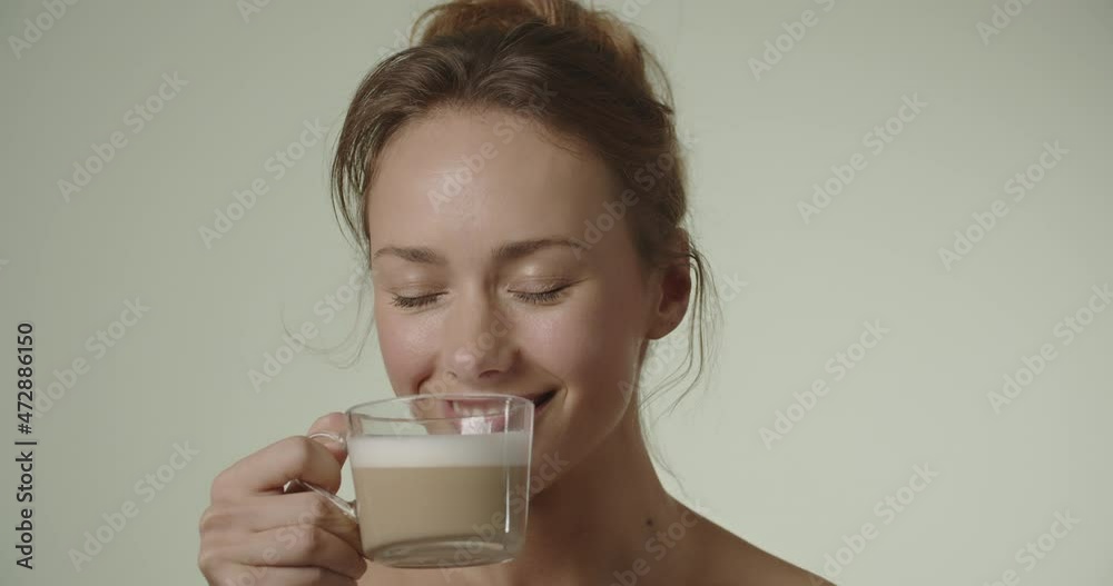 Young Woman Smiling And Taking A Drink Of Coffee