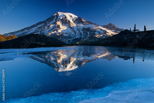 Washington State, Mount Rainier National Park, Tatoosh Range, Grinnell Glacier, Mount Rainier reflected in melt water pond