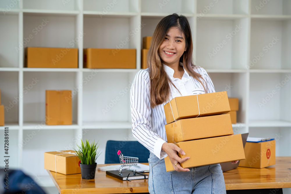 Portrait of Starting small businesses SME owners female entrepreneurs working, box and check online orders to prepare to pack the boxes, sell to customers, sme business ideas online. Portrait of Starting small businesses SME owners female entrepreneurs working, box and check online orders to prepare to pack the boxes, sell to customers, sme business ideas online.