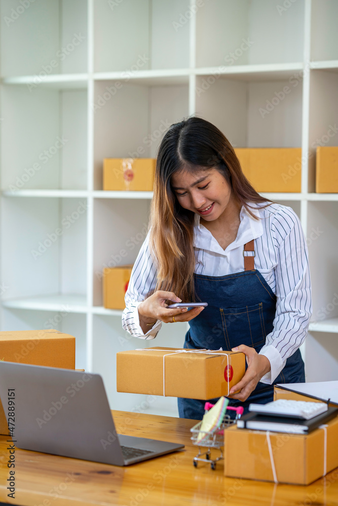 Startup small business SME, Entrepreneur Closeup owner checking product on stock scan qr code working at home,online marketing packaging delivery box, SME e-commerce concept. Startup small business SME, Entrepreneur Closeup owner checking product on stock scan qr code working at home,online marketing packaging delivery box, SME e-commerce concept.