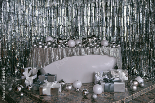 New Year's photo zone: bathroom with balls and gifts, silver tinsel
