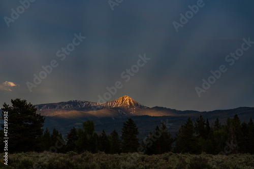 USA, Wyoming, Grand Teton National Park. Crepuscular rays and mountain landsc...