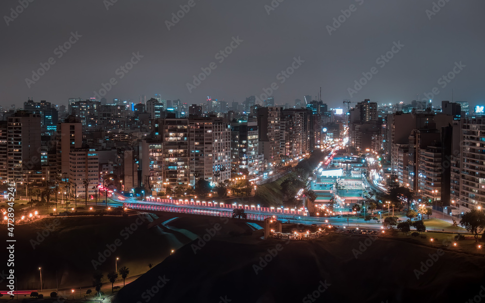 Aerial night drone view over the bridge of Villena Rey from Miraflores District in Lima, Peru